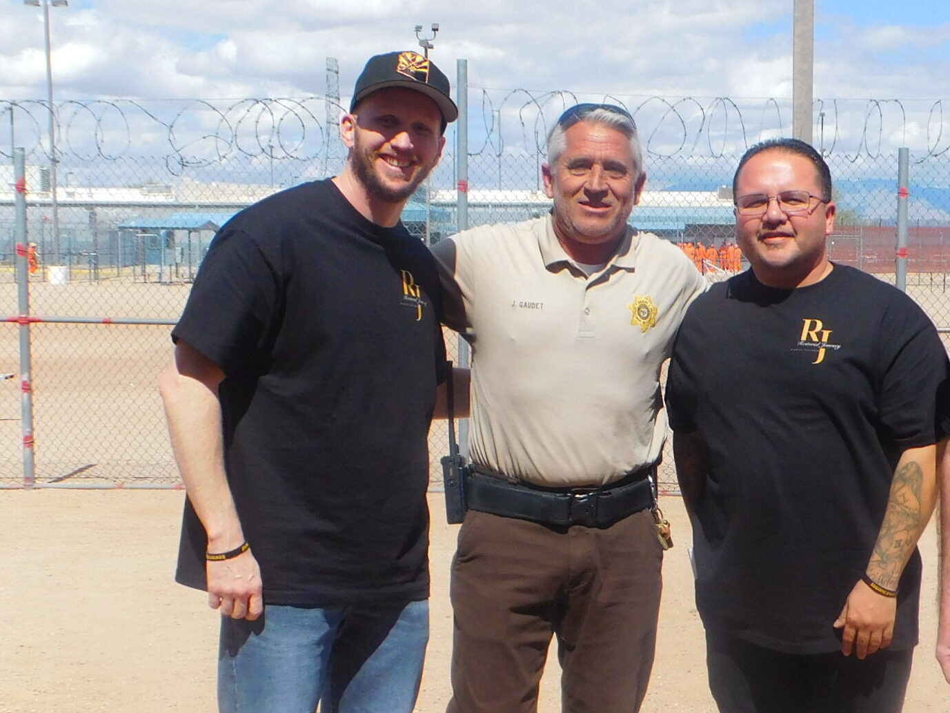 Group of 4 men stands next to each other and smiling
